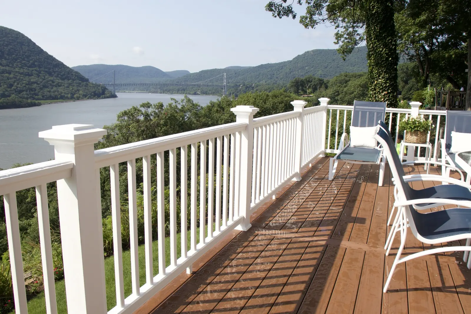 Composite deck with white vinyl railing overlooking the Hudson Valley